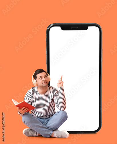 Young man with book, headph...