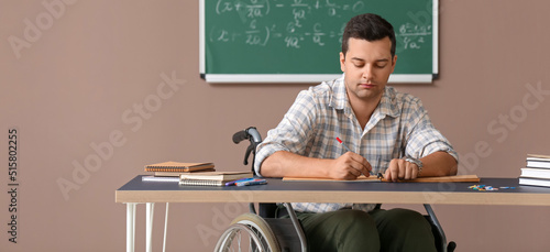 Male teacher in wheelchair ...