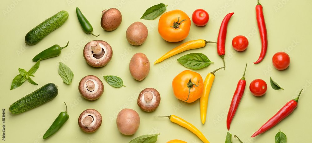 Assortment of fresh vegetables and mushrooms on light green background Assortment of fresh vegetables and mushrooms on light green background