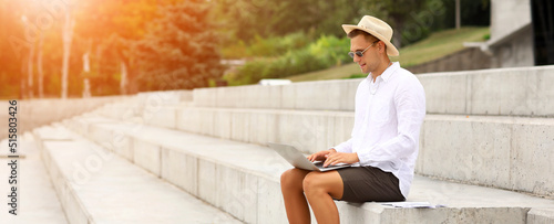 Young male blogger with lap...