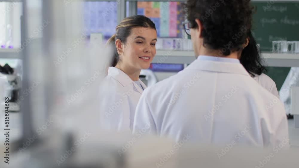science, work and people concept - international group of happy scientists talking in laboratory science, work and people concept - international group of happy scientists talking in laboratory