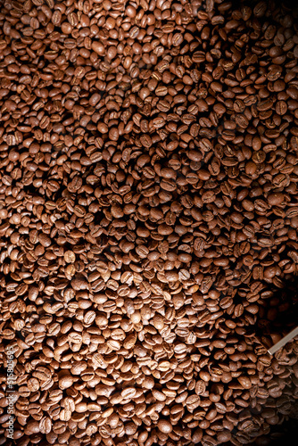 Top view of roasted coffee beans mixing in mixer