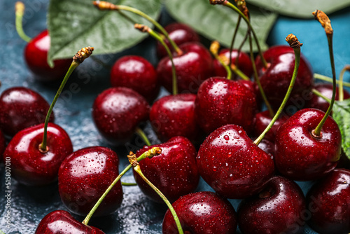 Fotografering Ripe cherries with water drops on table, closeup