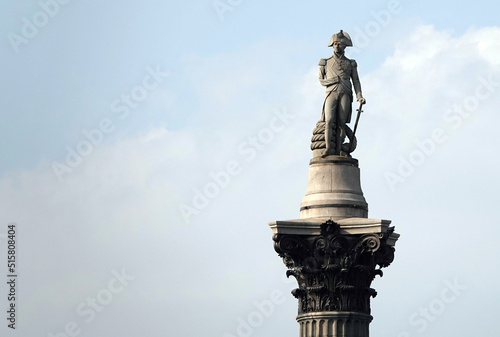 A low angle view of the statue of Admiral Horatio Nelson on top of Nelson's Column in Trafalgar Square, London.  photo