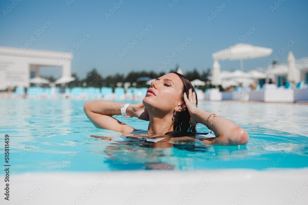 beautiful girl swimming in the pool, summer vacation by the pool, girl drinking cocktail by the pool