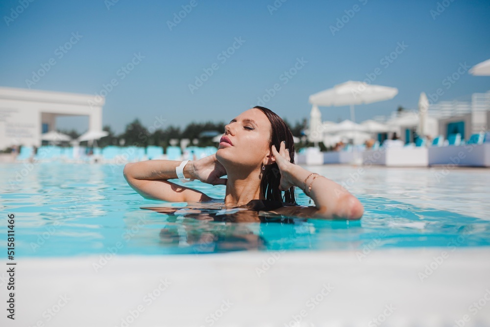 beautiful girl swimming in the pool, summer vacation by the pool, girl drinking cocktail by the pool