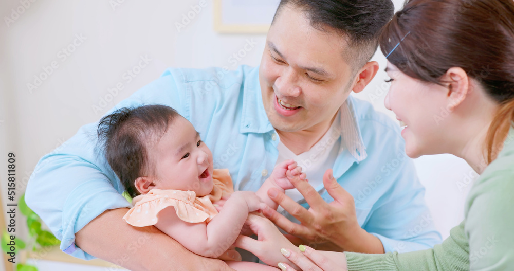 Young parents play with baby
