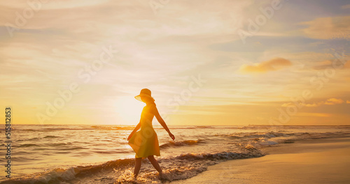 woman walking by beach photo