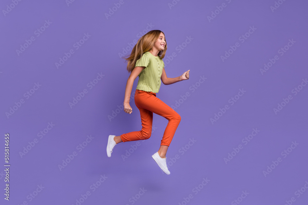 Full size profile portrait of crazy cheerful girl jump hurry rush empty space isolated on purple color background