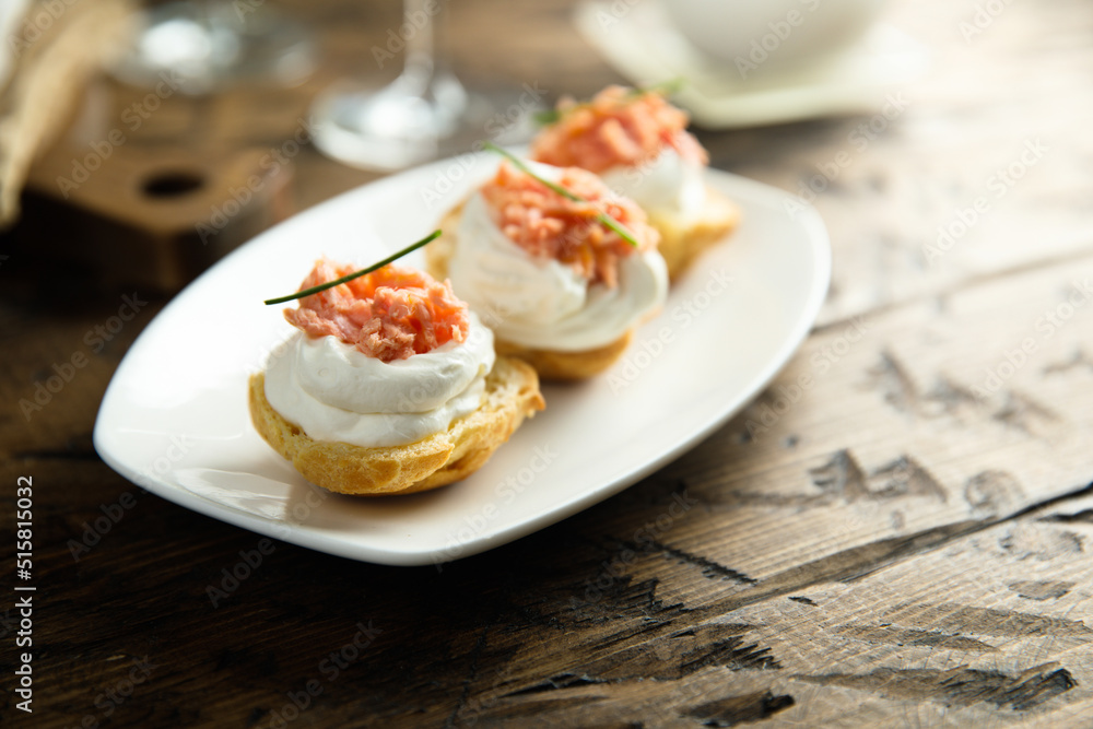 Homemade profiteroles with salmon and cream cheese Homemade profiteroles with salmon and cream cheese