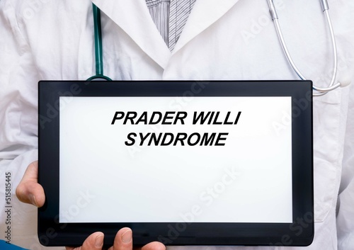 Prader Willi Syndrome.  Doctor with rare or orphan disease text on tablet screen Prader Willi Syndrome photo