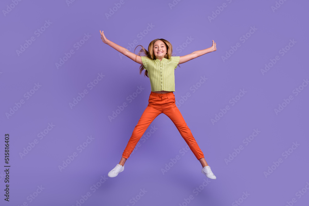 Full body portrait of overjoyed energetic girl jumping make star figure isolated on purple color background