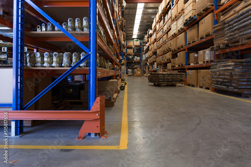 Warehouse interior with racks of boxes and concrete floor photo