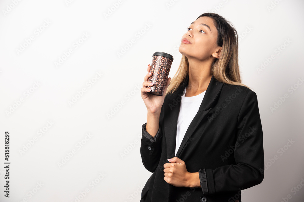 Business woman holding cup and posing on white background Business woman holding cup and posing on white background