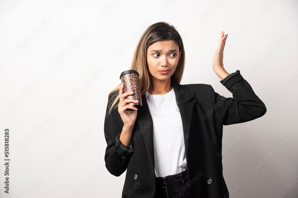 Business woman holding cup and posing on white background Business woman holding cup and posing on white background