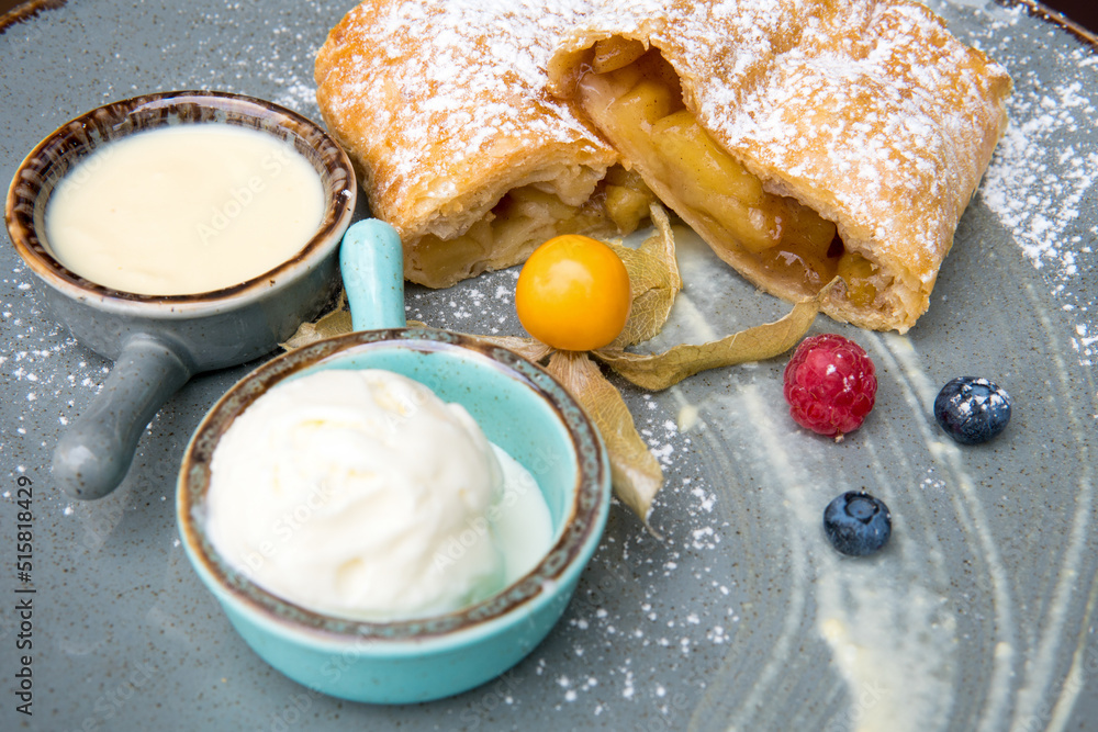 Apple strudel with honey and ice cream and fresh berries