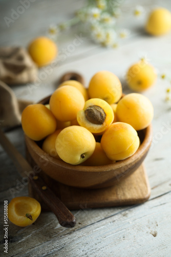 Fresh ripe apricots in a wooden bowl
