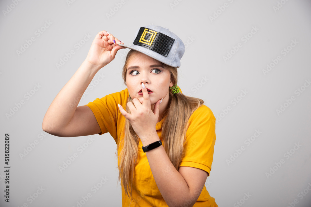 Portrait of cute woman posing with a gray stylish cap Portrait of cute woman posing with a gray stylish cap