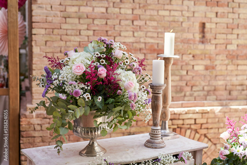 decoration with assorted flowers and candles in wooden candle holders