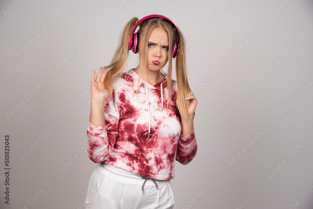 Portrait of young woman in pink outfit posing on gray background Portrait of young woman in pink outfit posing on gray background