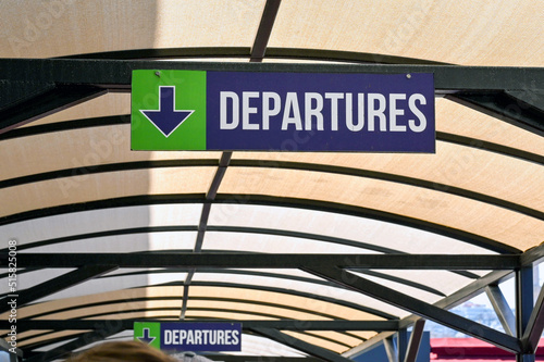 Sign showing the way to departures at a ferry terminal.