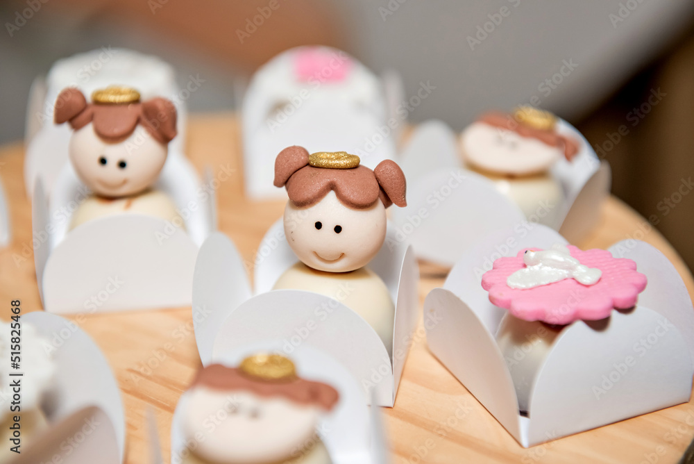 Obraz premium baptism celebration decorated candies table, angel baptism decoration sweet.