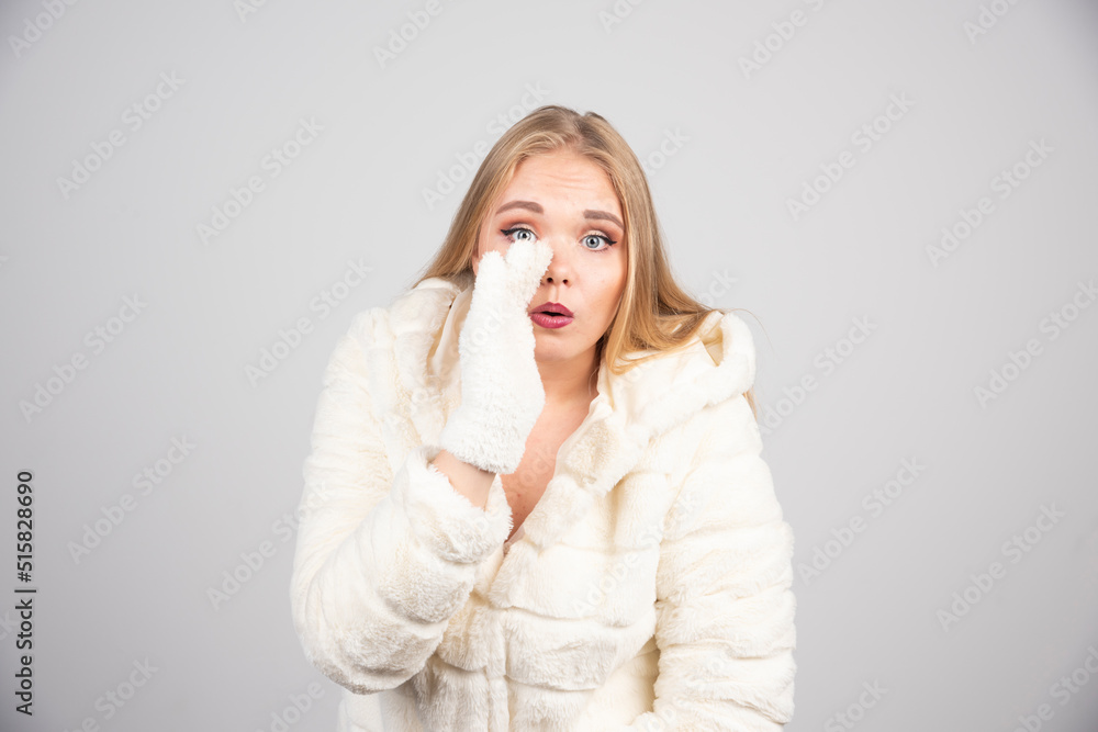 Beautiful woman in winter outfit telling something to camera Beautiful woman in winter outfit telling something to camera