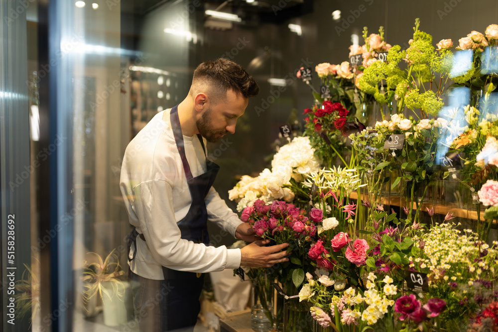 flower shop worker collects a gorgeous bouquet in the refrigerator