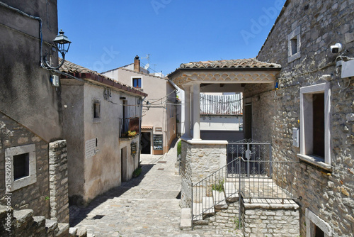 A narrow street between the old houses of Pietrelcina, a village in the province of Benevento, Italy.	