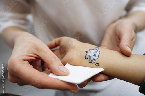 Girl at a dentist having a sticker in the shape of tooth