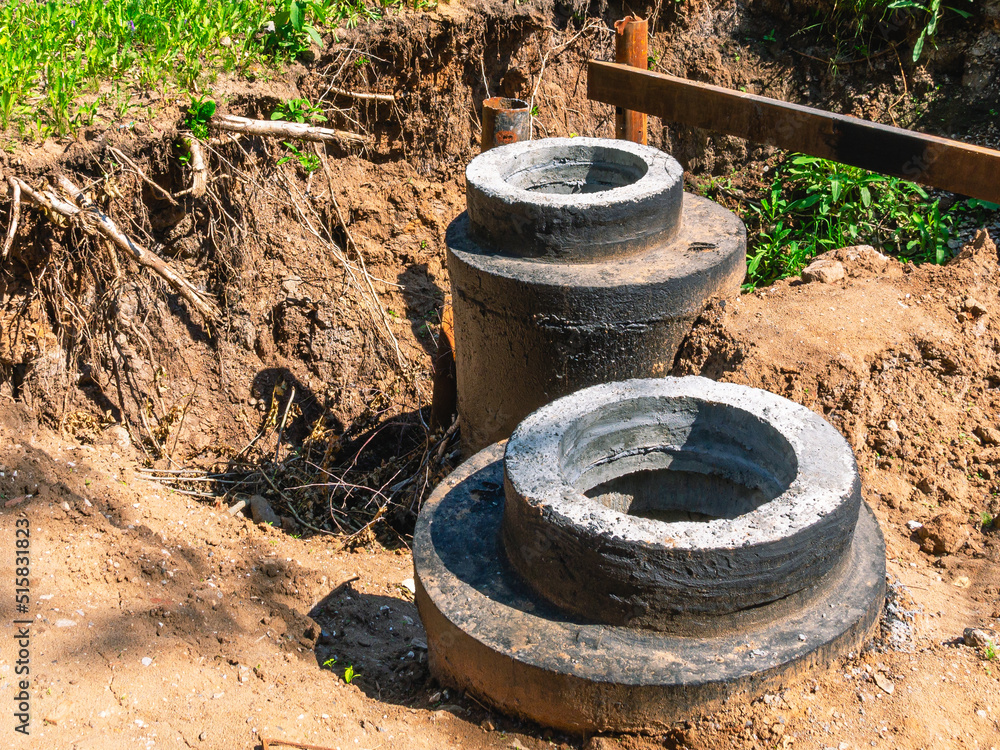 Installation of sewer wells. Installation of sewer networks. Laying of the pipeline underground. A trench for the repair of construction communications.