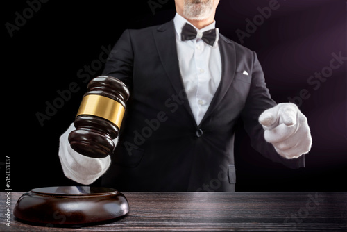 Fotografiet Auctioneer, salesperson with gavel at public auction