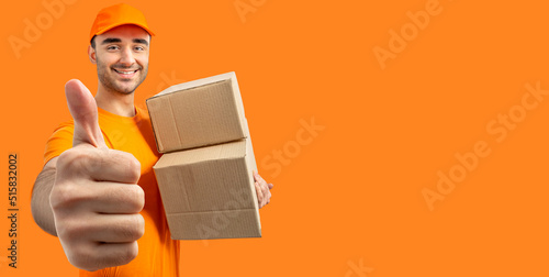 Delivery man with a box, thumb up. Courier in uniform cap and t-shirt service fast delivering orders. Young guy holding a cardboard package. Character on isolated white background for mockup design photo