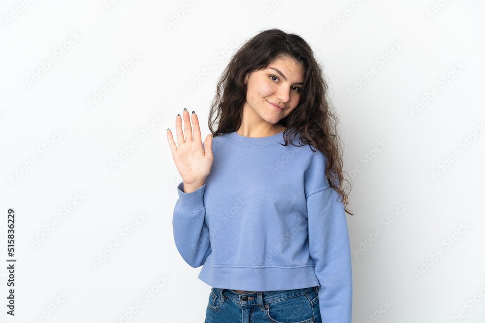 Teenager Russian girl isolated on white background saluting with hand with happy expression Teenager Russian girl isolated on white background saluting with hand with happy expression