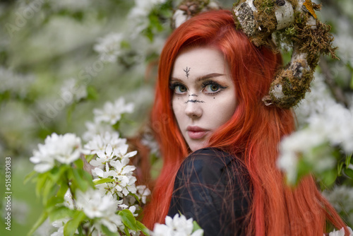 Close-up portrait of a red-haired witch with moss-covered horns