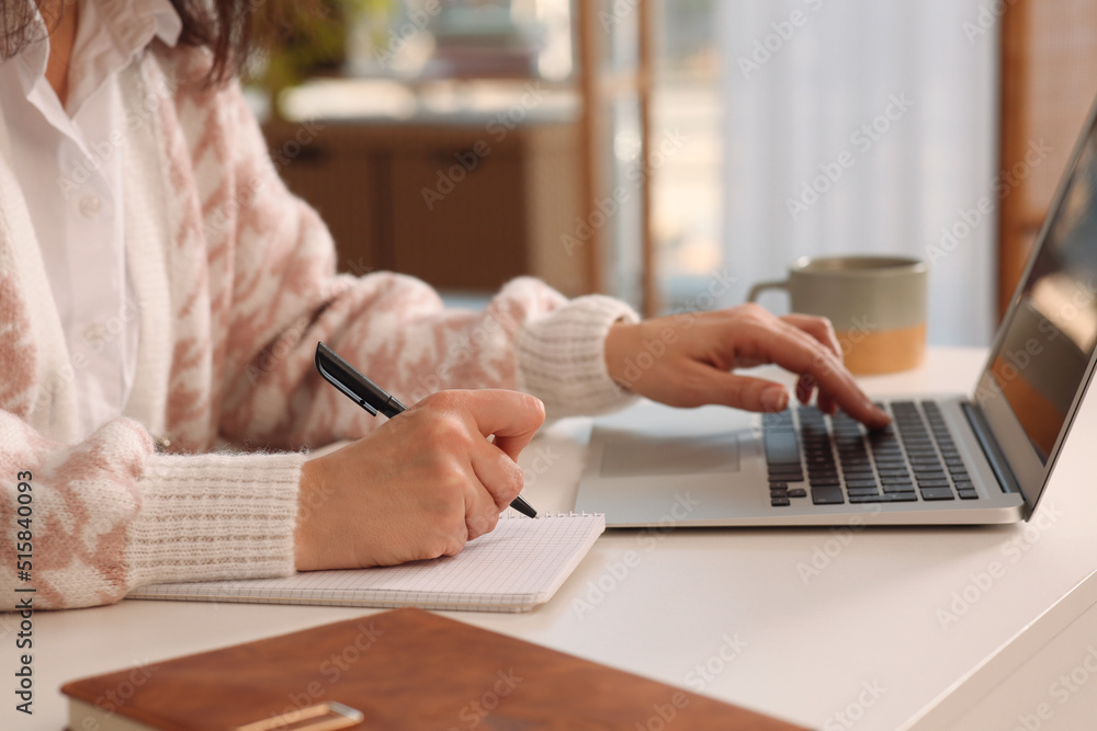 Woman with modern laptop learning at home, closeup Woman with modern laptop learning at home, closeup