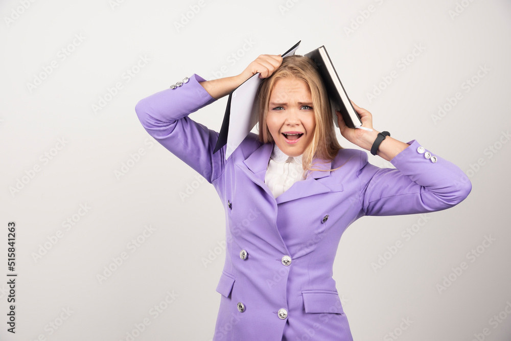 Young screaming woman holding tablet on white background Young screaming woman holding tablet on white background