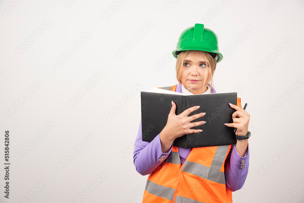 Female builder in helmet with tablet on white background Female builder in helmet with tablet on white background