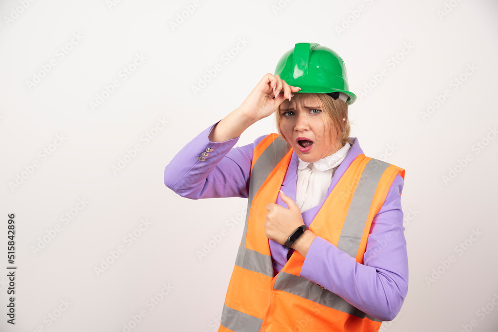 Female builder in helmet on white background