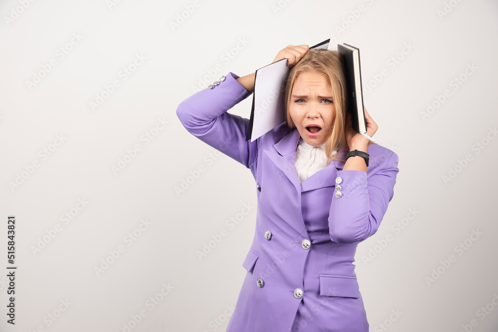 Young shocked woman holding tablet on white background Young shocked woman holding tablet on white background