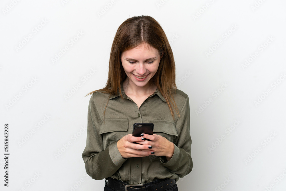 Young English woman isolated on white background sending a message with the mobile Young English woman isolated on white background sending a message with the mobile