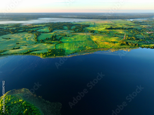 Lake in rural land. Freshwater Lakes. Water supply problems and water deficit. Surface and groundwater pollution. Global drought crisis. Drink water safe. Lake at countryside with green farm field.