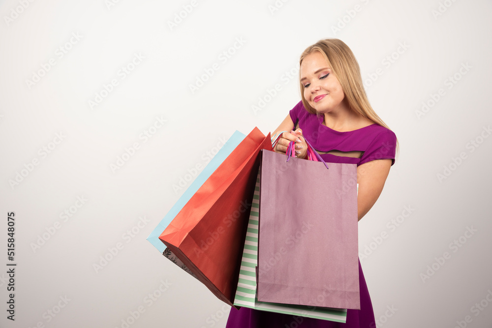 Beautiful woman holding bunch of shopping bags