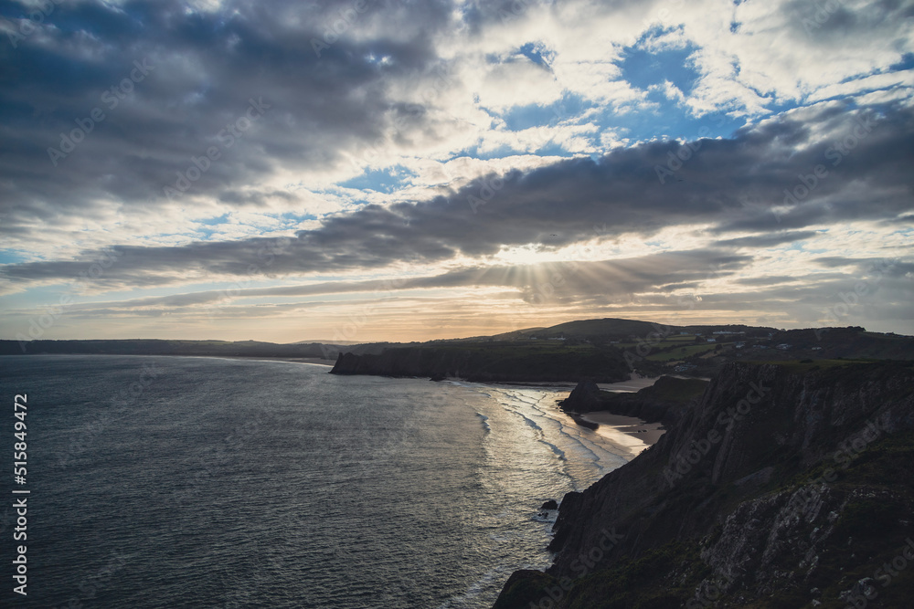 sunset over three cliffs bay