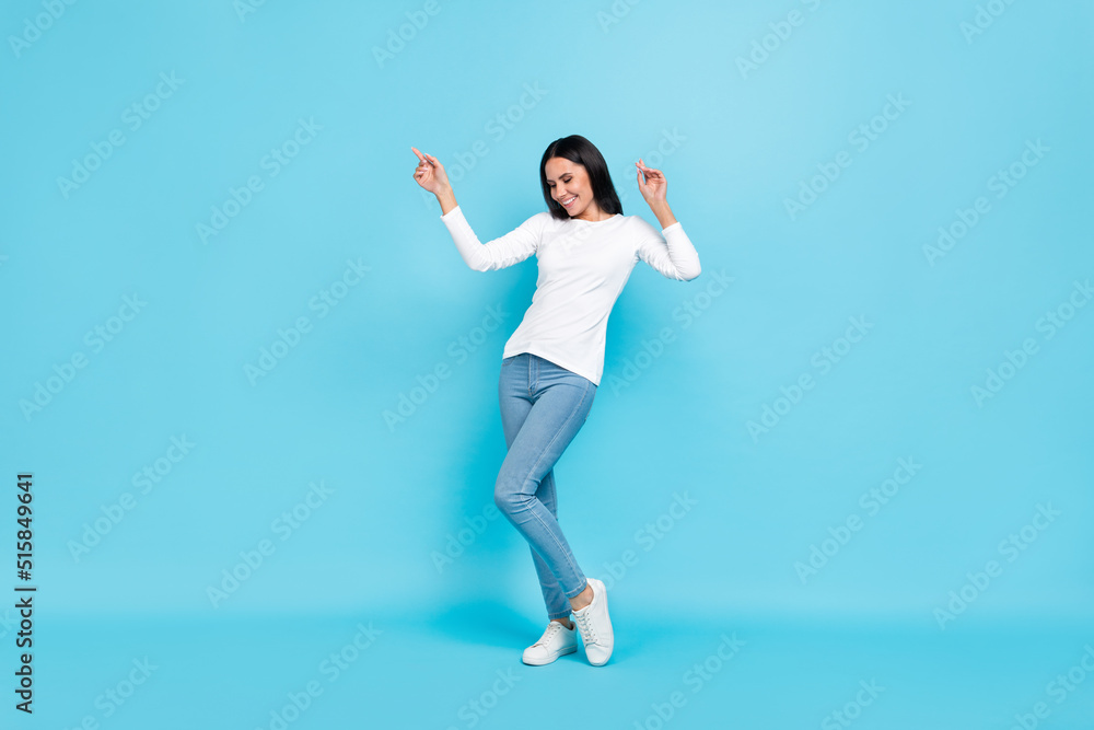 Full body photo of young pretty woman have fun dance chill clubber isolated over blue color background