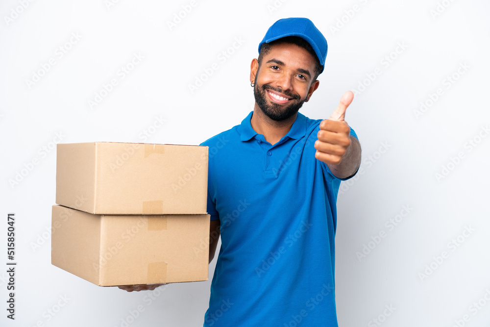 Delivery Brazilian man isolated on white background with thumbs up because something good has happened Delivery Brazilian man isolated on white background with thumbs up because something good has happened