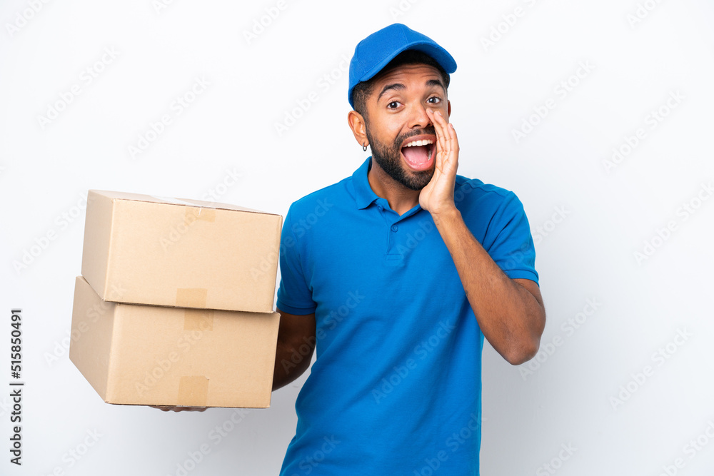 Delivery Brazilian man isolated on white background shouting with mouth wide open Delivery Brazilian man isolated on white background shouting with mouth wide open