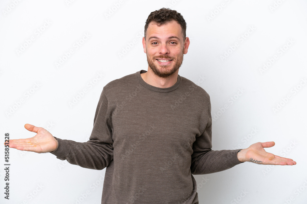 Young Brazilian man isolated on white background having doubts Young Brazilian man isolated on white background having doubts