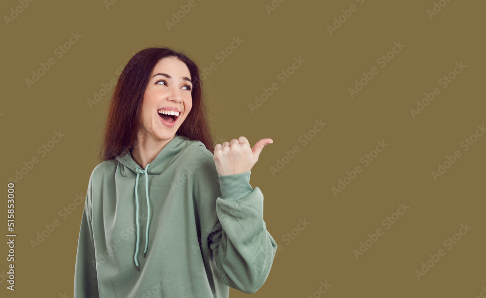 Smiling young Caucasian woman isolated on green studio background point at copy space aside. Happy funny girl recommend good offer or promotion deal. Client recommendation concept. Smiling young Caucasian woman isolated on green studio background point at copy space aside. Happy funny girl recommend good offer or promotion deal. Client recommendation concept.