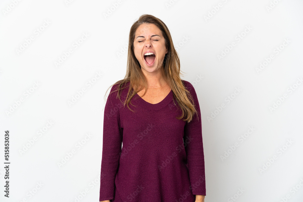 Middle age Brazilian woman isolated on white background shouting to the front with mouth wide open Middle age Brazilian woman isolated on white background shouting to the front with mouth wide open